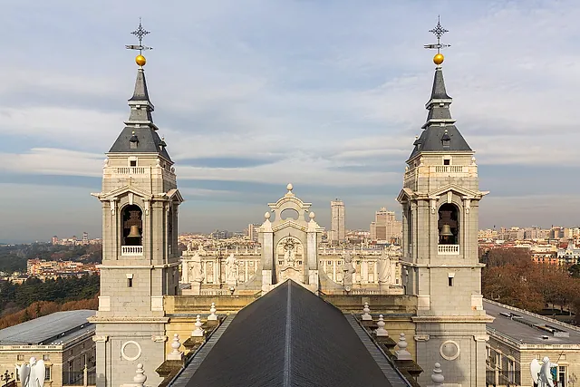 The two bell towers of the Almudena Cathedral seen from above, with the city of Madrid behind