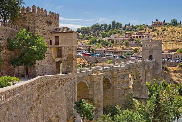 The medieval Puente de San Martín in Toledo, with its arches over the river and the old town behind