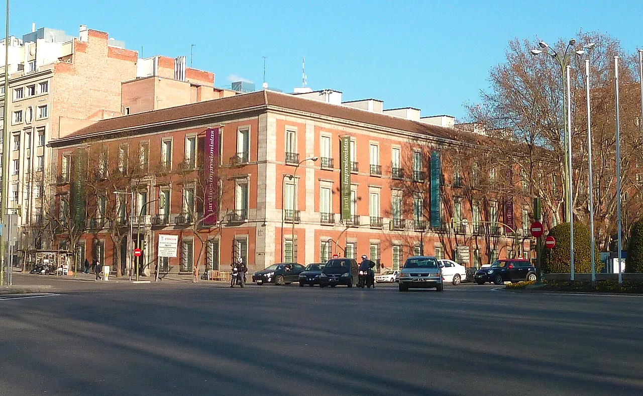 The pink-brick and stone façade of the Thyssen-Bornemisza Museum along the Paseo del Prado